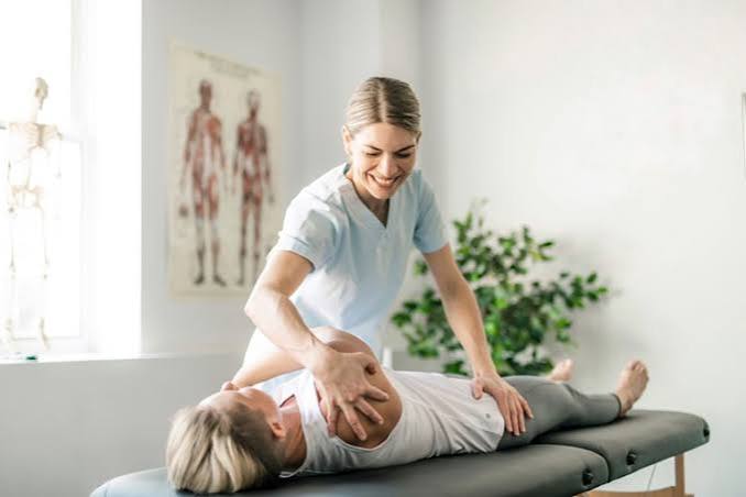 Physiotherapist mobilising a patient's shoulder on a treatment table at Carla Thorne Physio in Cape Town